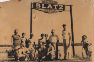 Old owners photo of people at Christy's Landing under a Blatz Beer sign.